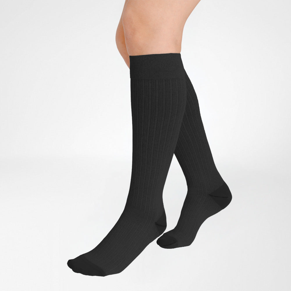 A pair of Bauerfeind Medical Compression knee-high cotton air socks worn on a person's legs, shown against a plain white background.